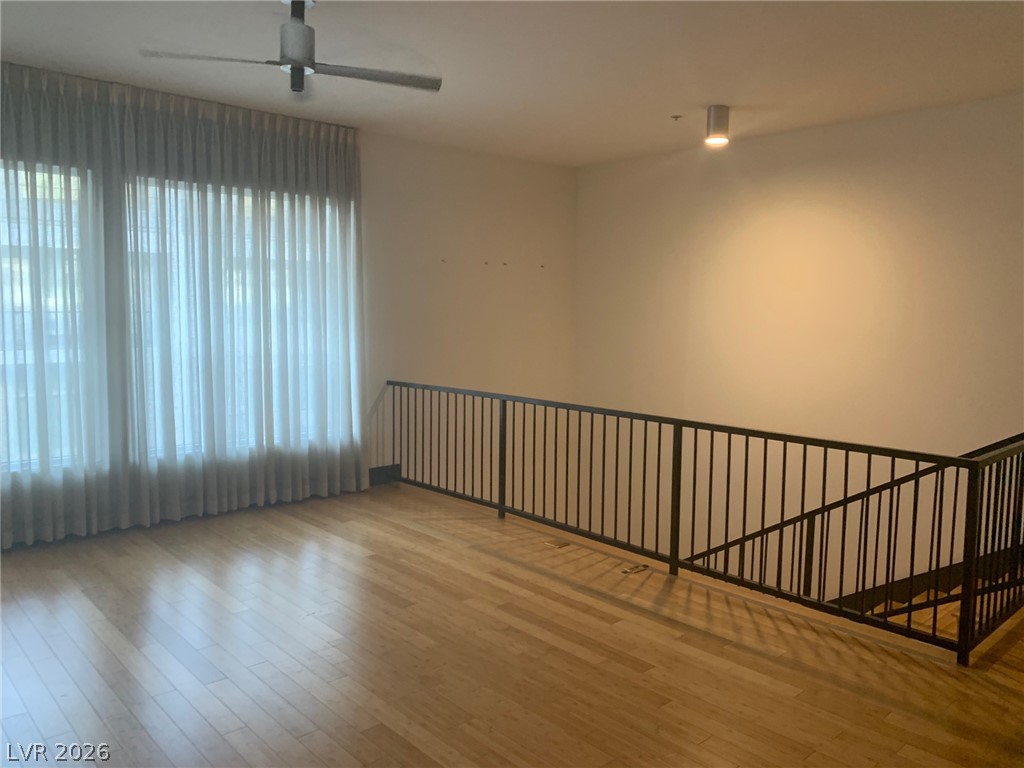 2775 West Pebble Road, Unit 325 Las Vegas, NV 89123 - Photo 3 of 7 Luminous interior with hardwood flooring and an open stairway invites natural light.