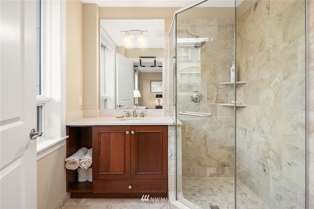 a bathroom with a bathtub shower sink mirror and toilet