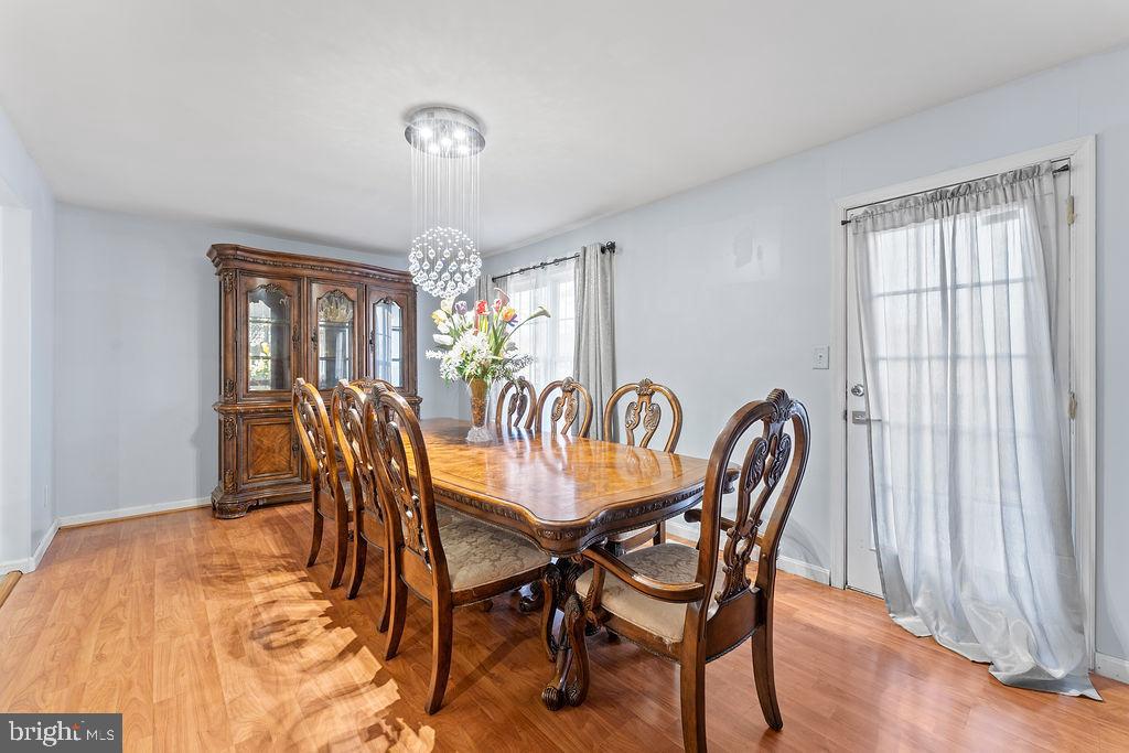 10335 Citation Way Ruther Glen, VA 22546 - Photo 14 of 47 a view of a dining room with furniture window and wooden floor
