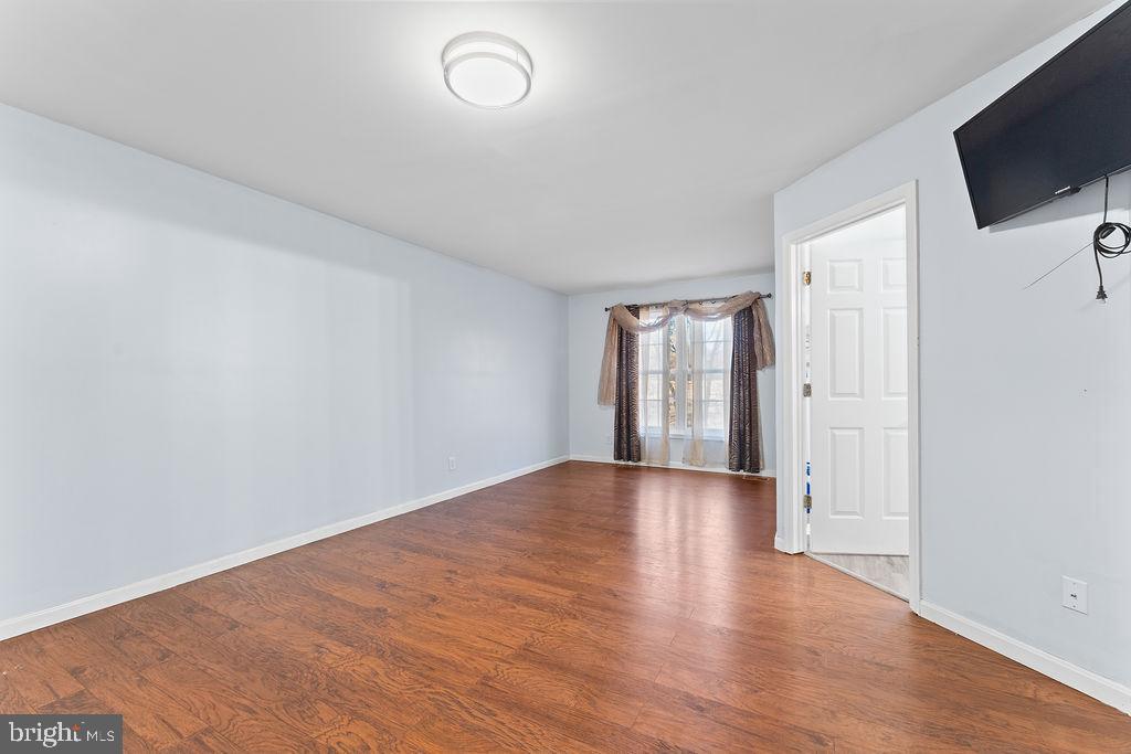 10335 Citation Way Ruther Glen, VA 22546 - Photo 16 of 47 a view of an empty room with wooden floor and windows