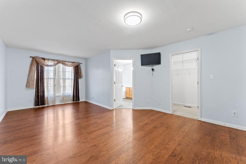 10335 Citation Way Ruther Glen, VA 22546 - Photo 17 of 47 an empty room with wooden floor and windows