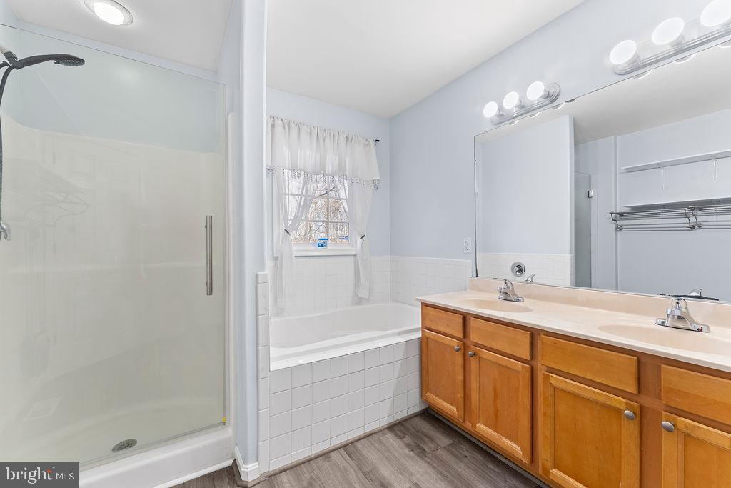 10335 Citation Way Ruther Glen, VA 22546 - Photo 19 of 47 a bathroom with a tub sink vanity granite and a shower