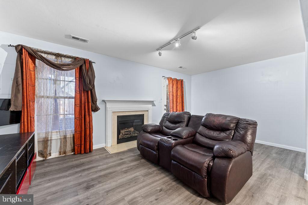 10335 Citation Way Ruther Glen, VA 22546 - Photo 29 of 47 a living room with furniture a fireplace and a flat screen tv