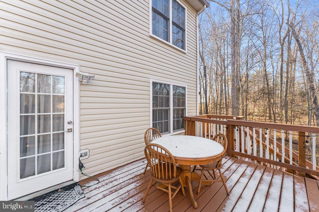 10335 Citation Way Ruther Glen, VA 22546 - Photo 37 of 47 a view of a patio with table and chairs with wooden floor and fence