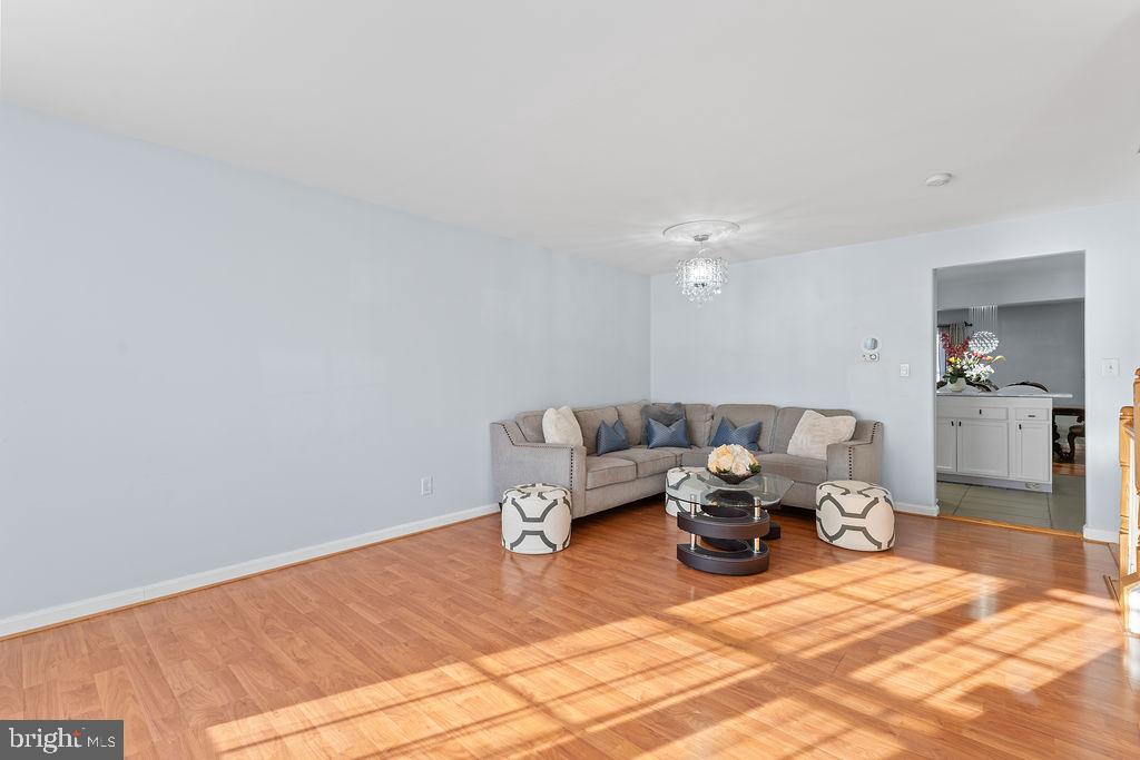 10335 Citation Way Ruther Glen, VA 22546 - Photo 4 of 47 a living room with furniture a chandelier and a rug