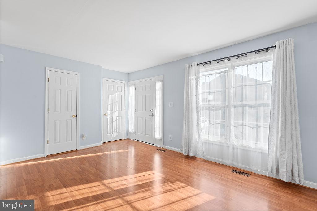 10335 Citation Way Ruther Glen, VA 22546 - Photo 6 of 47 a view of an empty room with wooden floor and a window