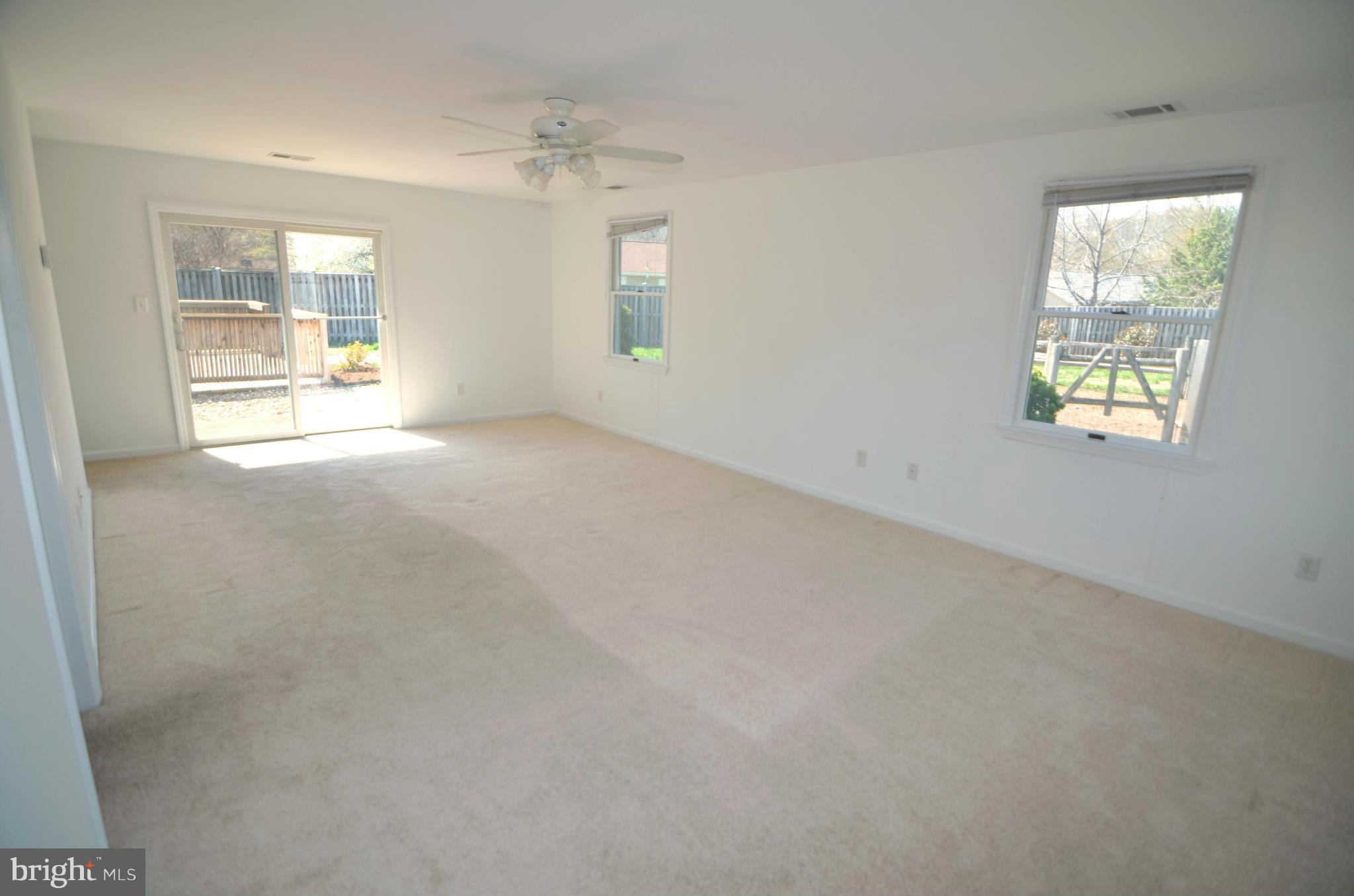 8222 Grainfield Road Severn, MD 21144 - Photo 14 of 30 an empty room with windows and mirror