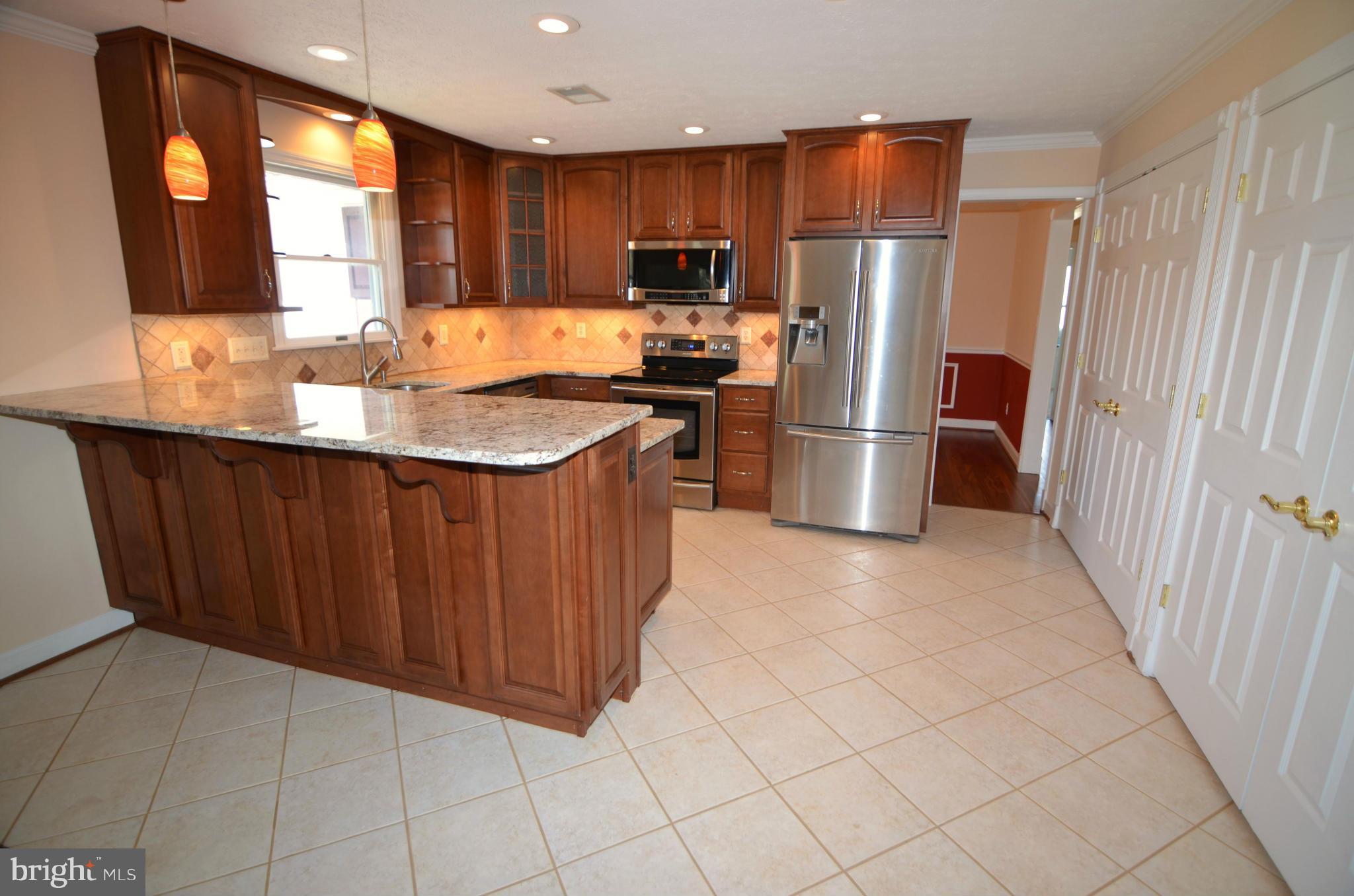 8222 Grainfield Road Severn, MD 21144 - Photo 8 of 30 a kitchen with stainless steel appliances granite countertop a refrigerator oven a sink and dishwasher