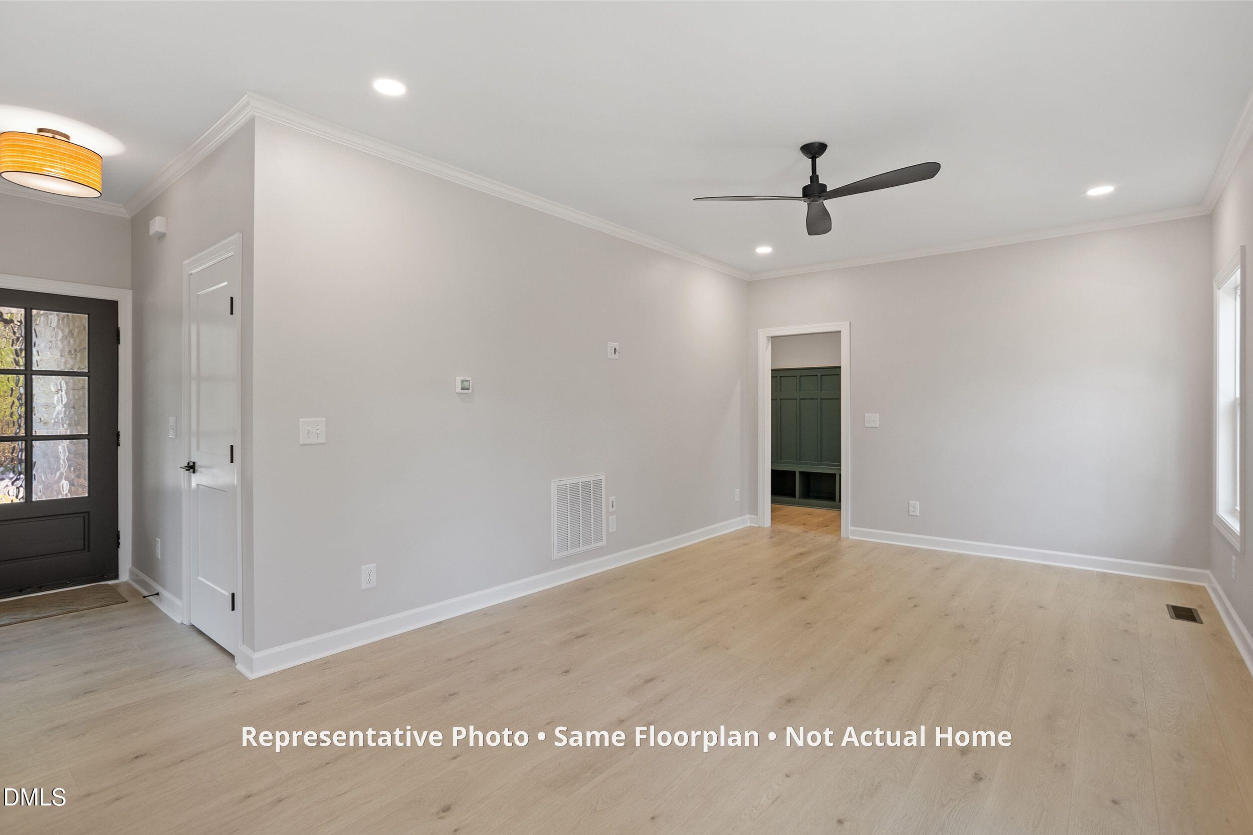 931 Woodland Road Creedmoor, NC 27522 - Photo 11 of 45 an empty room with windows and entrance