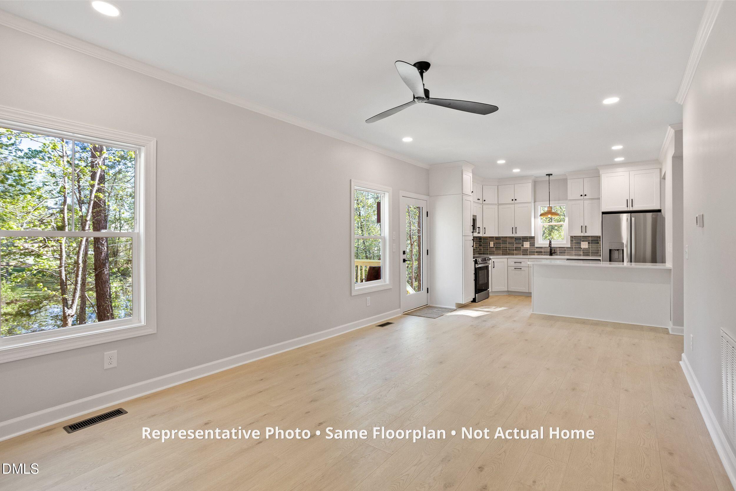 931 Woodland Road Creedmoor, NC 27522 - Photo 13 of 45 a view of a kitchen with a sink and wooden floor