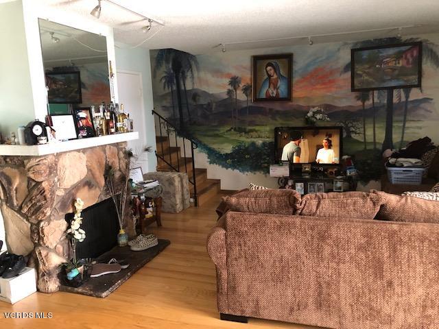 561 Spring Road, Unit 43 Moorpark, CA 93021 - Photo 2 of 8 a living room with furniture and a fireplace