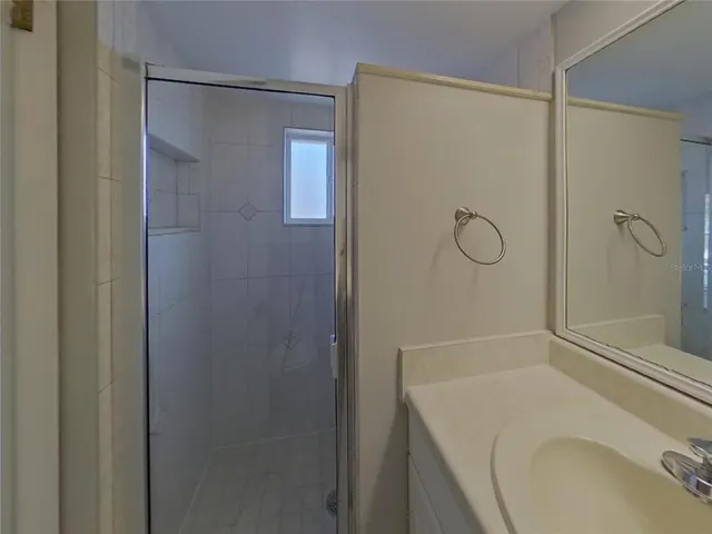 a bathroom with a sink and shower