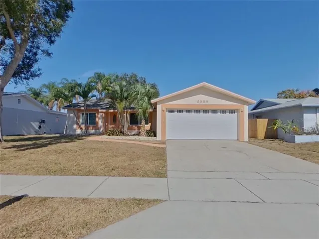 a view of a house with a yard and garage