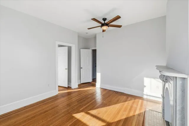a view of a livingroom with wooden floor and white walls