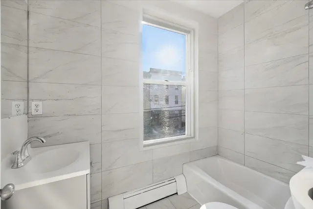 a bathroom with a bathtub and window