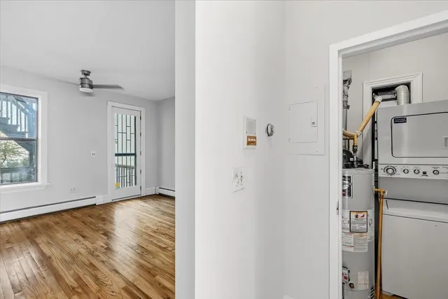 a view of a hallway with wooden floor and closet