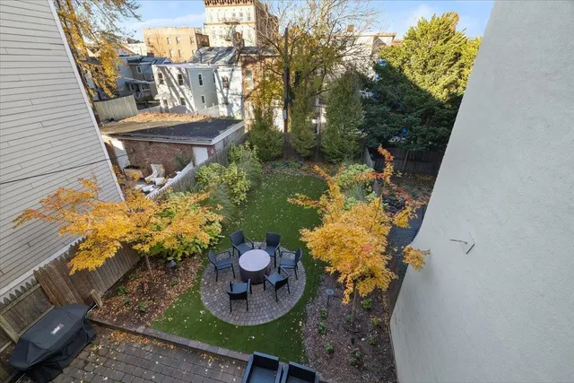 a view of a backyard with chair and a potted plant