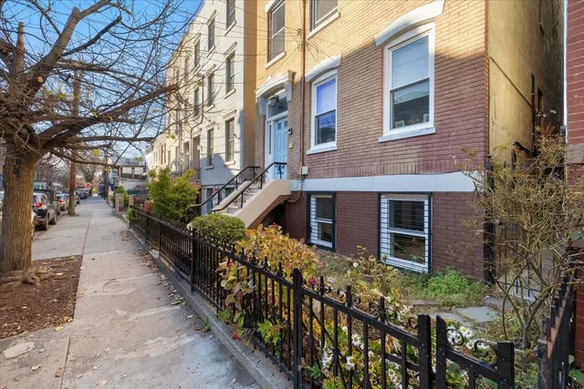 a view of a house with brick walls