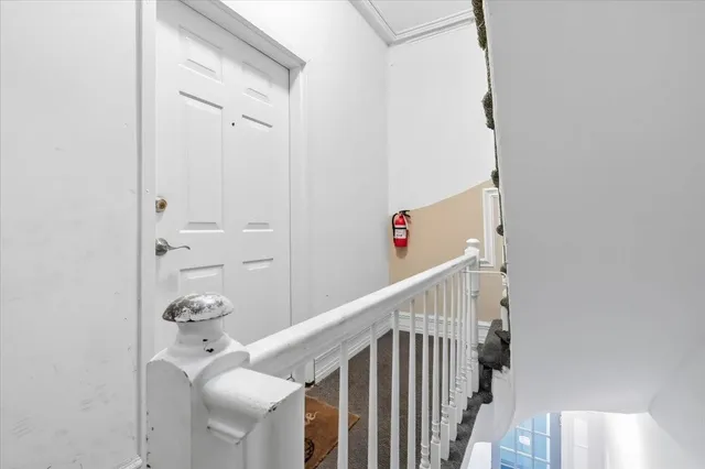 a view of staircase with white walls