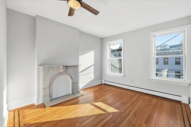 a view of a livingroom with wooden floor and a window