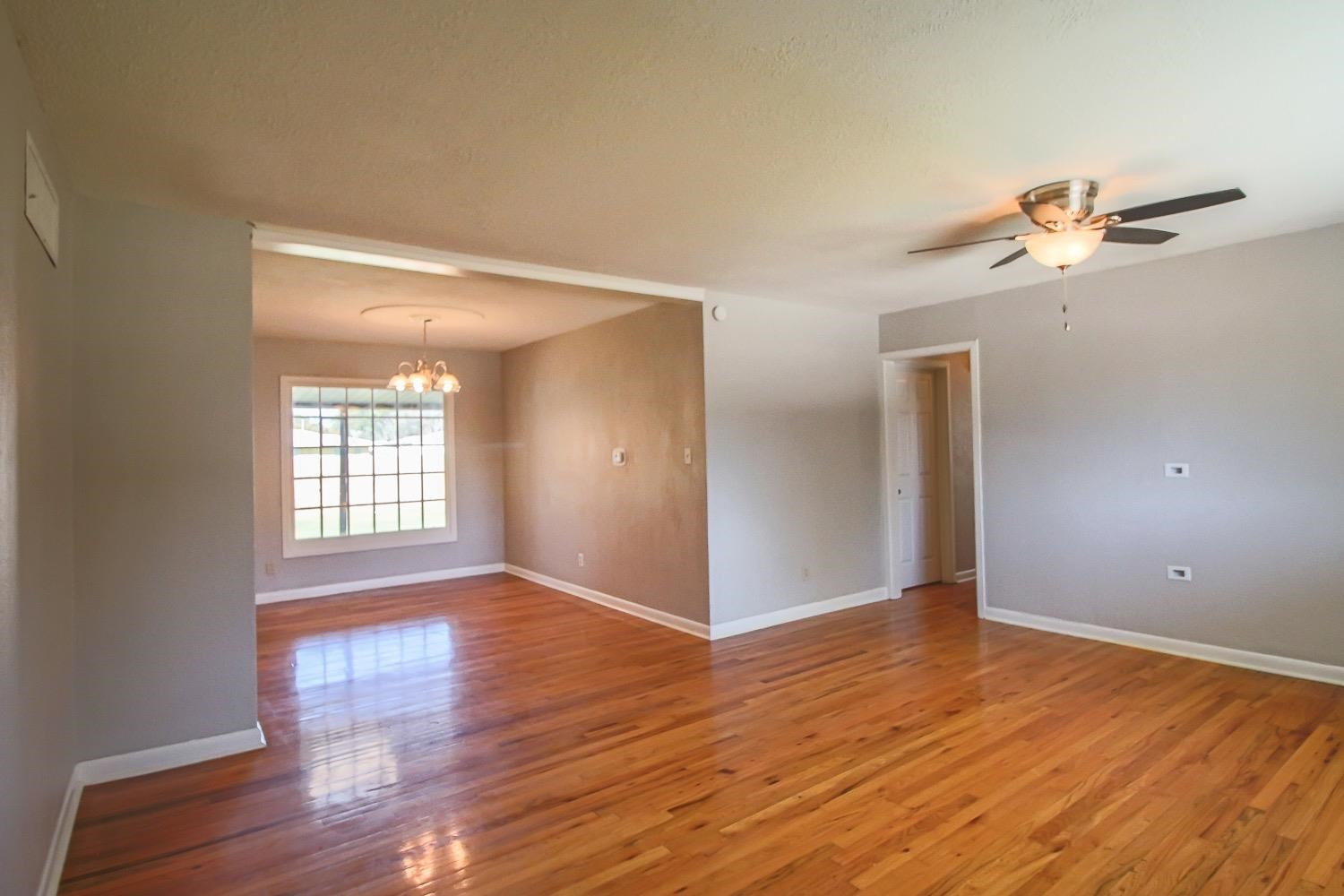 3814 32nd Street Lubbock, TX 79410 - Photo 5 of 10 a view of empty room with wooden floor and fan