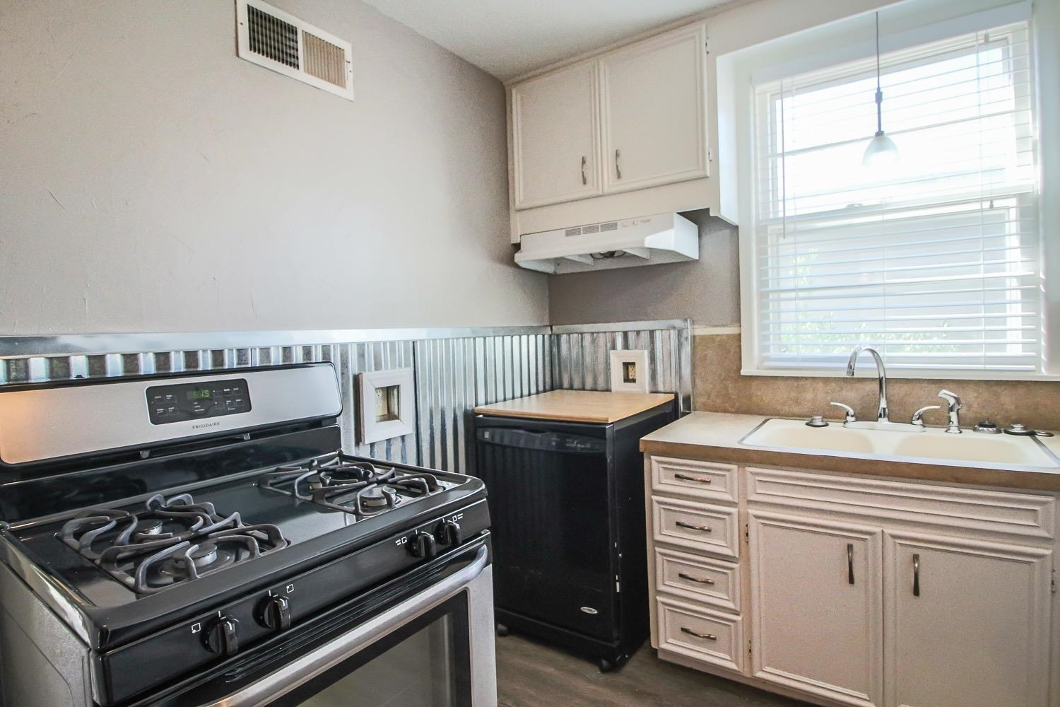 3814 32nd Street Lubbock, TX 79410 - Photo 8 of 10 a kitchen with a stove and a sink