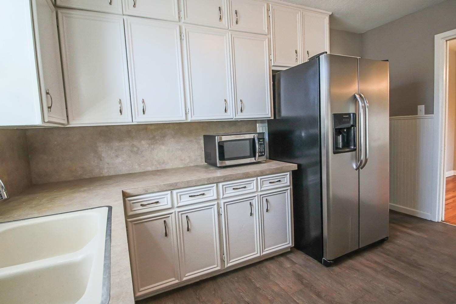 3814 32nd Street Lubbock, TX 79410 - Photo 9 of 10 a kitchen with cabinets and stainless steel appliances