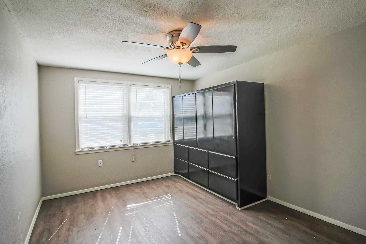 3814 32nd Street Lubbock, TX 79410 - Photo 10 of 10 wooden floor in an empty room with a window