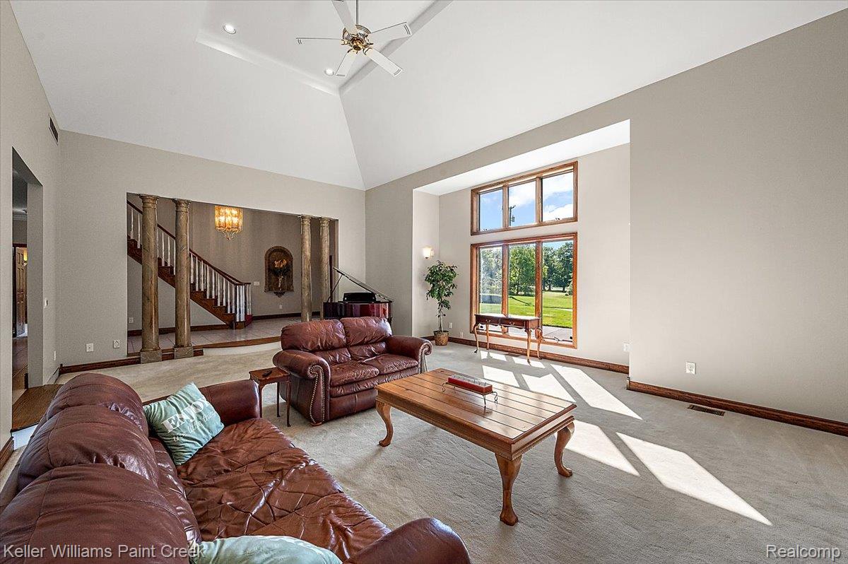 69069 Campground Road Romeo, MI 48065 - Photo 24 of 78 Spacious living area featuring a vaulted ceiling and a ceiling fan