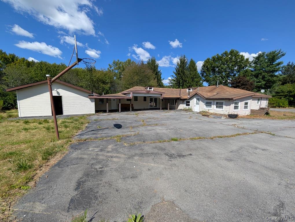 469 Eatontown Road Port Jervis, NY 12771 - Photo 2 of 10 a view of a house with backyard and a tree