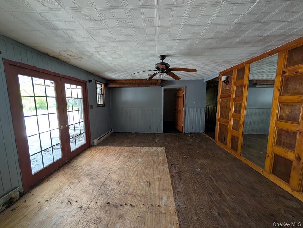 469 Eatontown Road Port Jervis, NY 12771 - Photo 5 of 10 a view of empty room with wooden floor and fan