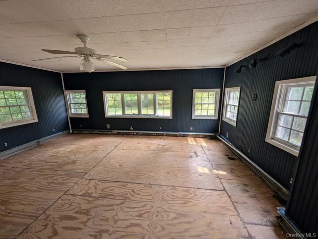 a view of an empty room with a fireplace and a window