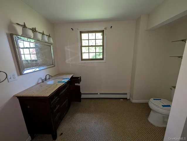 a room with a window and a table chair in it