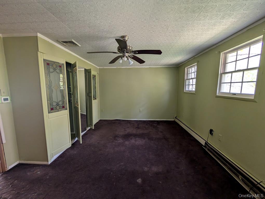 469 Eatontown Road Port Jervis, NY 12771 - Photo 9 of 10 an empty room with a window and a ceiling fan
