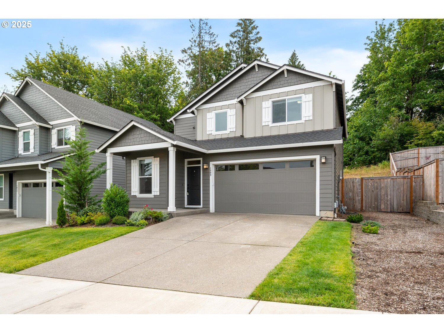1809 Northeast 169th Street Ridgefield, WA 98642 - Photo 1 of 47 a front view of a house with a yard and garage