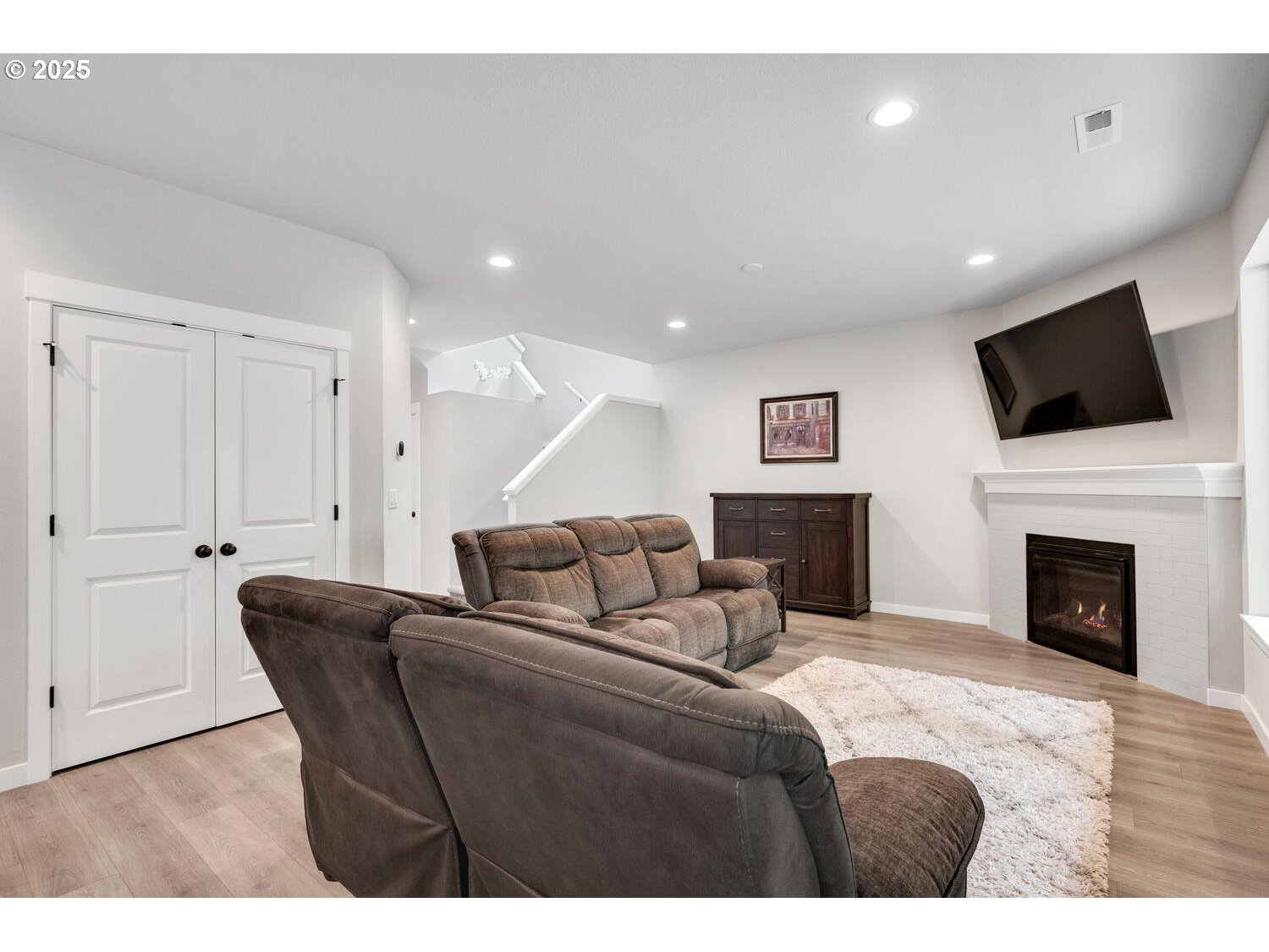 1809 Northeast 169th Street Ridgefield, WA 98642 - Photo 12 of 47 a living room with furniture a fireplace and a flat screen tv