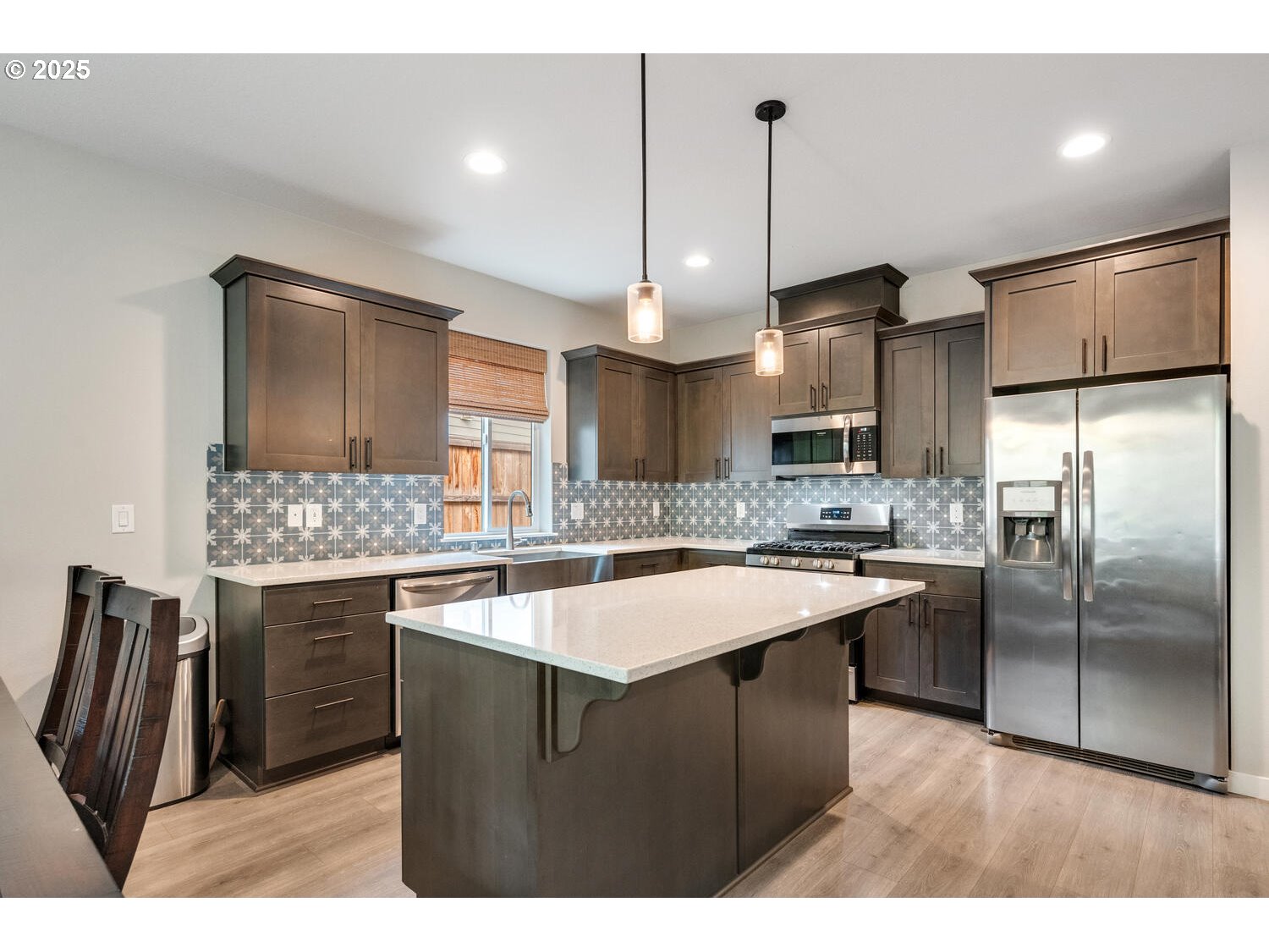 1809 Northeast 169th Street Ridgefield, WA 98642 - Photo 13 of 47 a kitchen with a sink a counter top space stainless steel appliances and cabinets