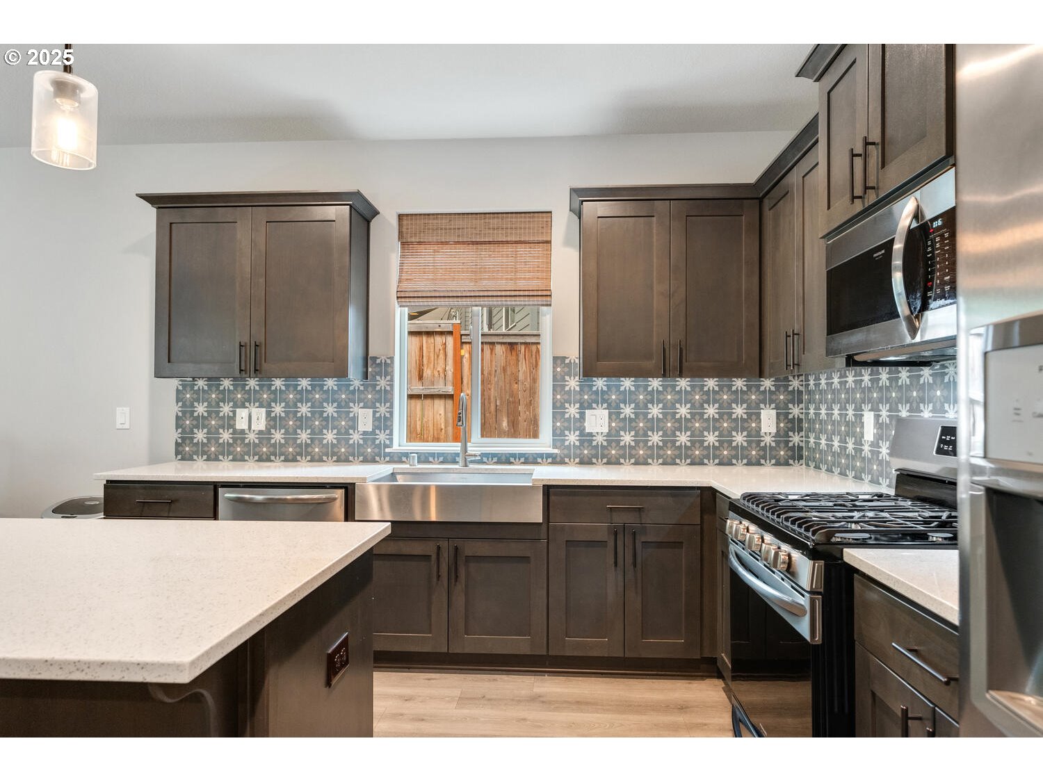 1809 Northeast 169th Street Ridgefield, WA 98642 - Photo 15 of 47 a kitchen with stainless steel appliances granite countertop a sink stove and refrigerator
