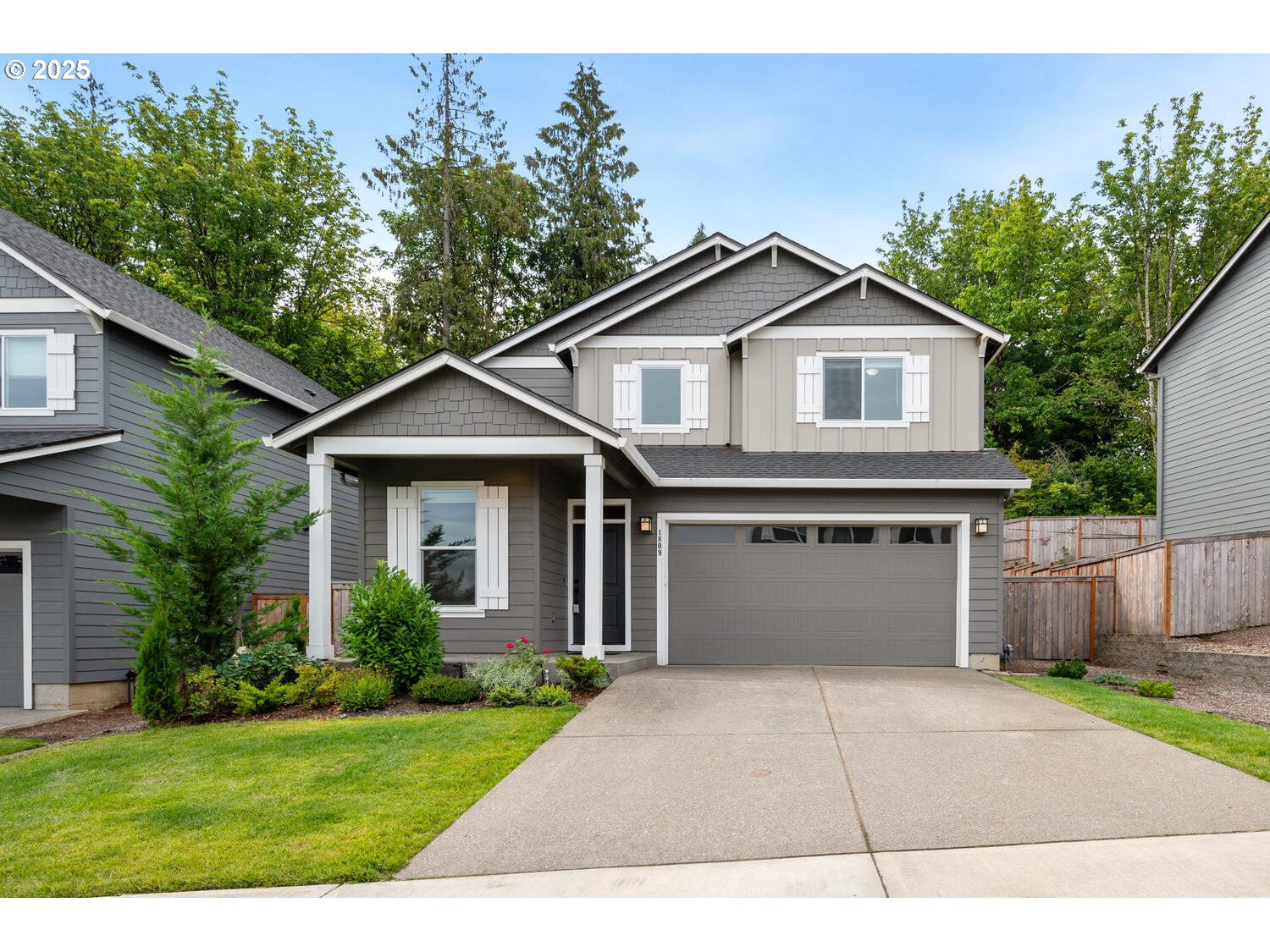 1809 Northeast 169th Street Ridgefield, WA 98642 - Photo 2 of 47 a front view of a house with a yard and garage