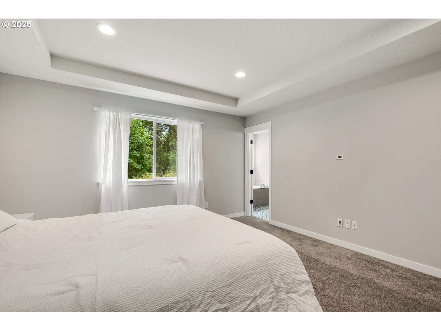 1809 Northeast 169th Street Ridgefield, WA 98642 - Photo 27 of 47 a large white bed in a room next to a window
