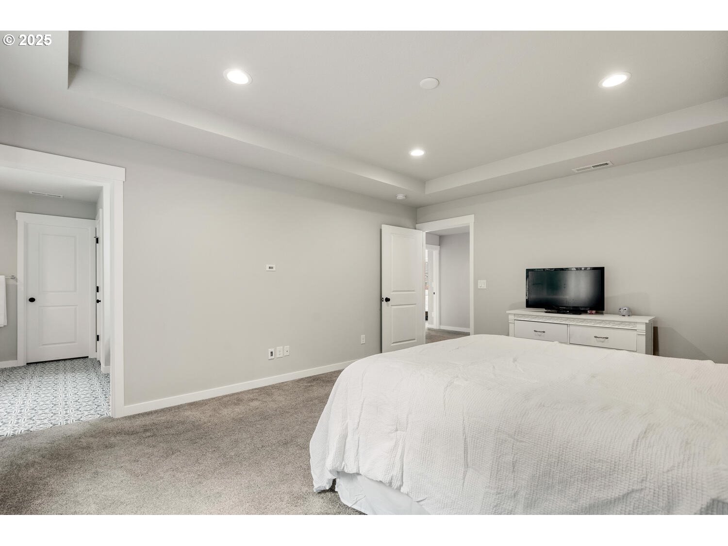1809 Northeast 169th Street Ridgefield, WA 98642 - Photo 28 of 47 a large bedroom with a bed and a flat screen tv