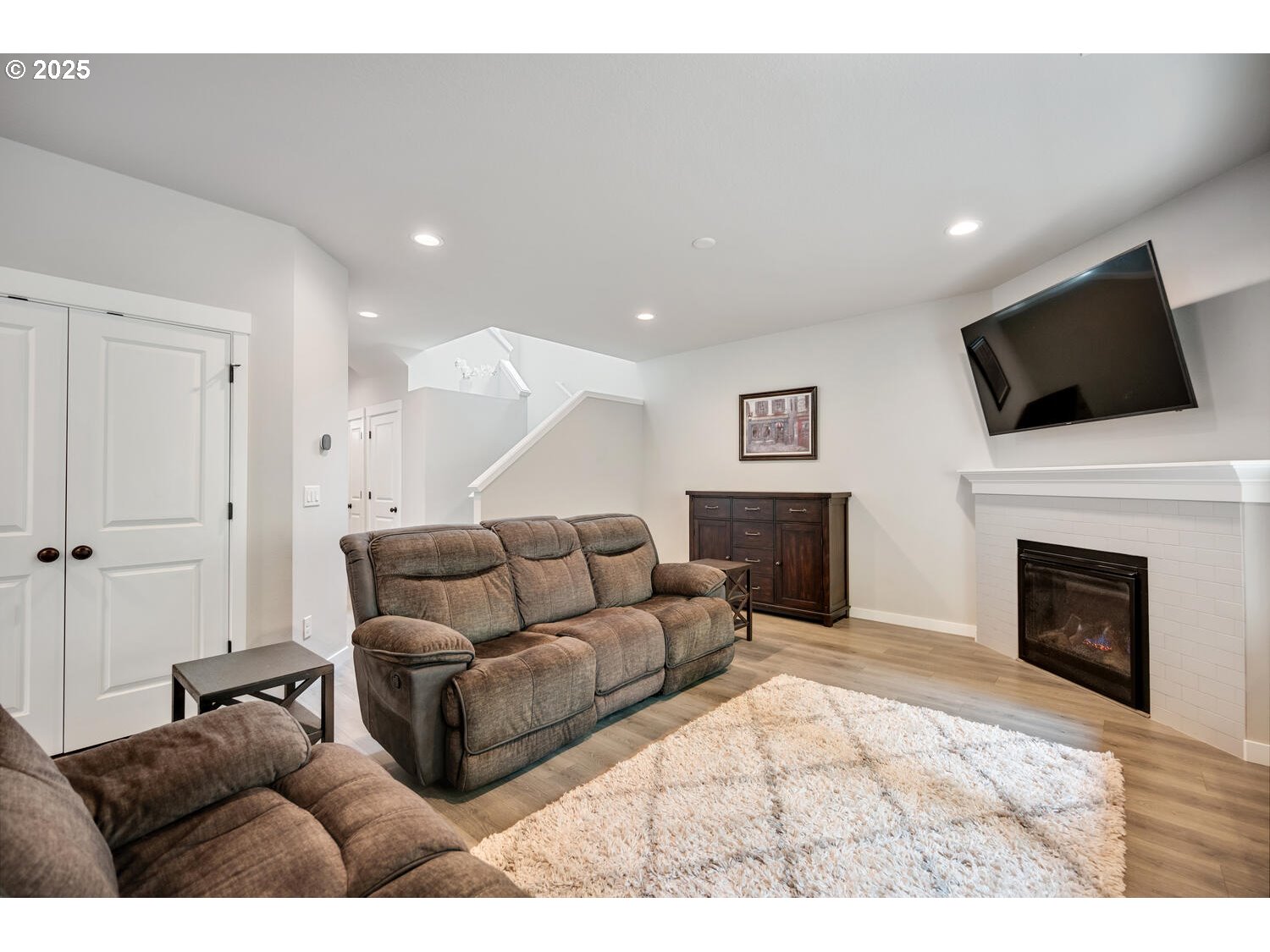 1809 Northeast 169th Street Ridgefield, WA 98642 - Photo 10 of 47 a living room with furniture a fireplace and a flat screen tv