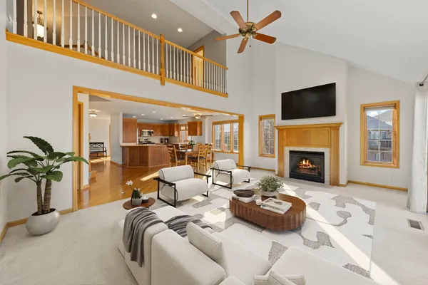 a bedroom with furniture a fireplace and a flat screen tv