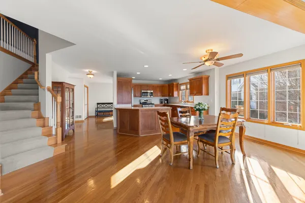 a dining room with furniture entryway wooden floor and a rug