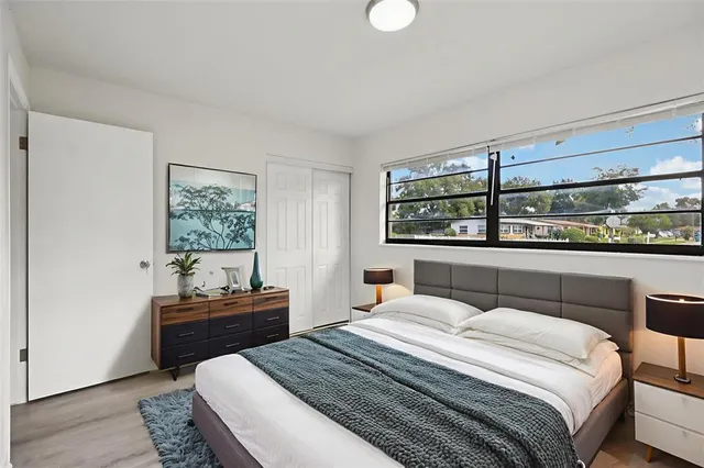 a bedroom with a bed and a window