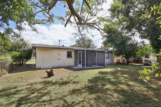 a view of a backyard with a tree