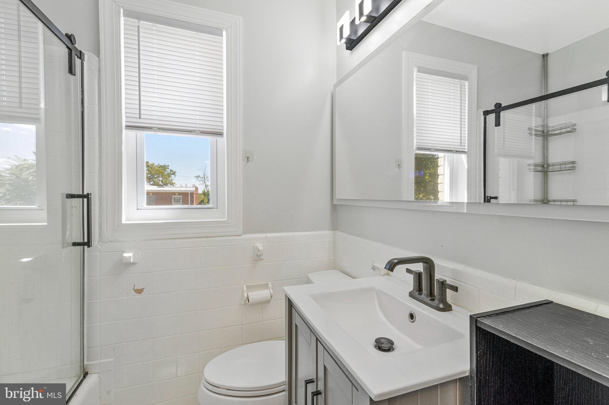 1925 Alabama Avenue Southeast Washington, DC 20020 - Photo 7 of 14 a bathroom with a sink mirror and toilet