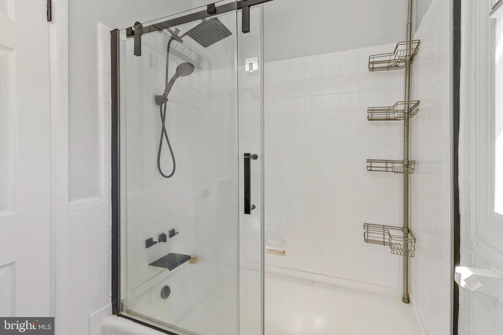 1925 Alabama Avenue Southeast Washington, DC 20020 - Photo 8 of 14 a bathroom with a glass shower door