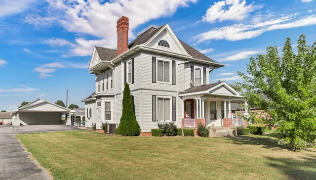 a front view of a house with a garden