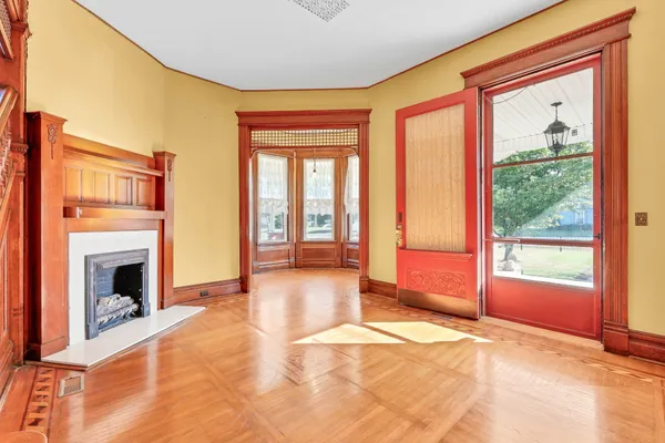 a view of a kitchen with kitchen island a sink wooden floor and a window